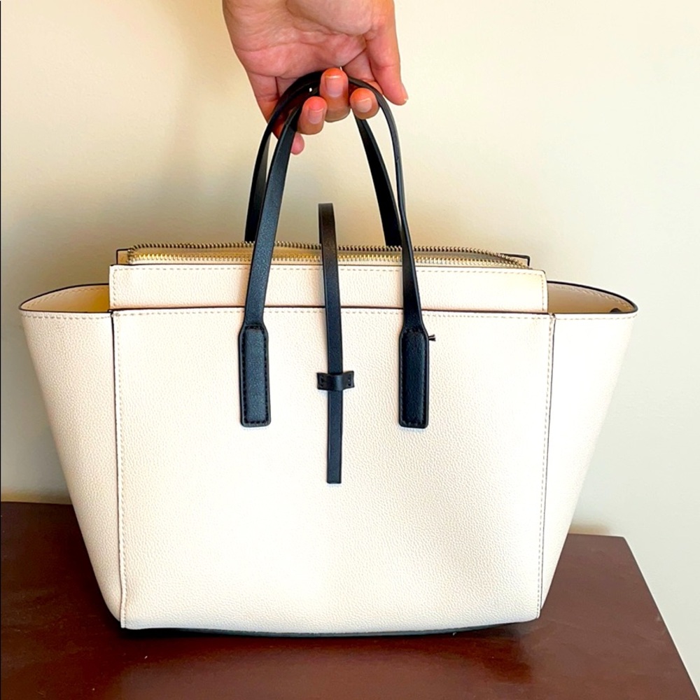 Pale pink feminine bag with black handles